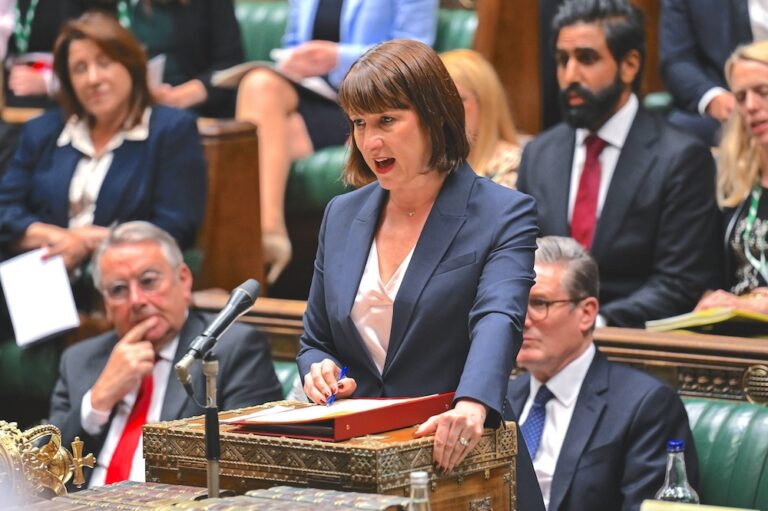 Rachel Reeves, UK Chancellor of the Exchequer, addresses Parliament from the dispatch box while Labour MPs look on